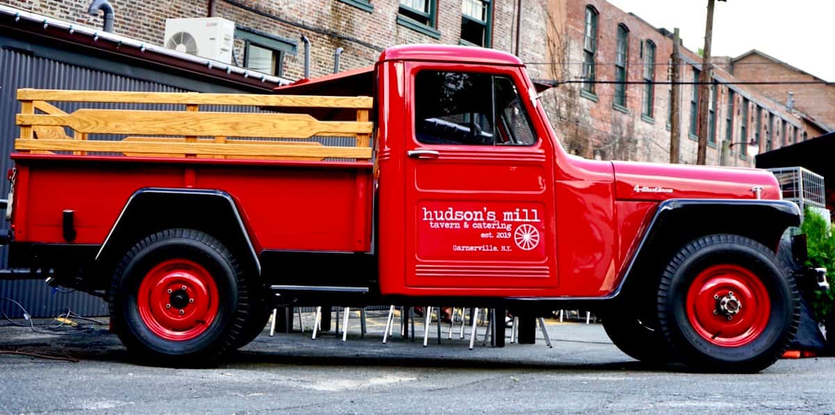 red truck with hudson's mill logo