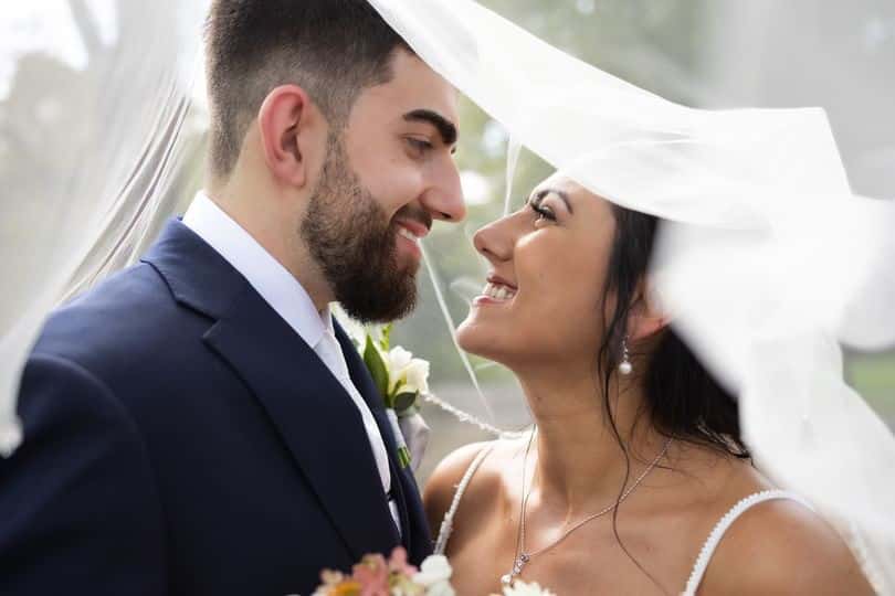 couple under wedding veil