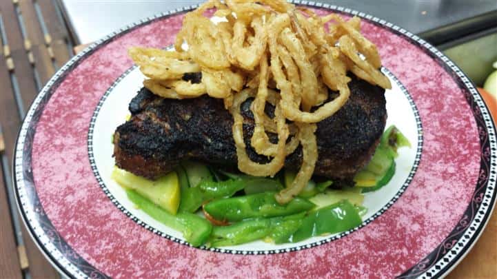 Blackened Rib Eye Steak With Cowboys onions over a bed of Vegetables