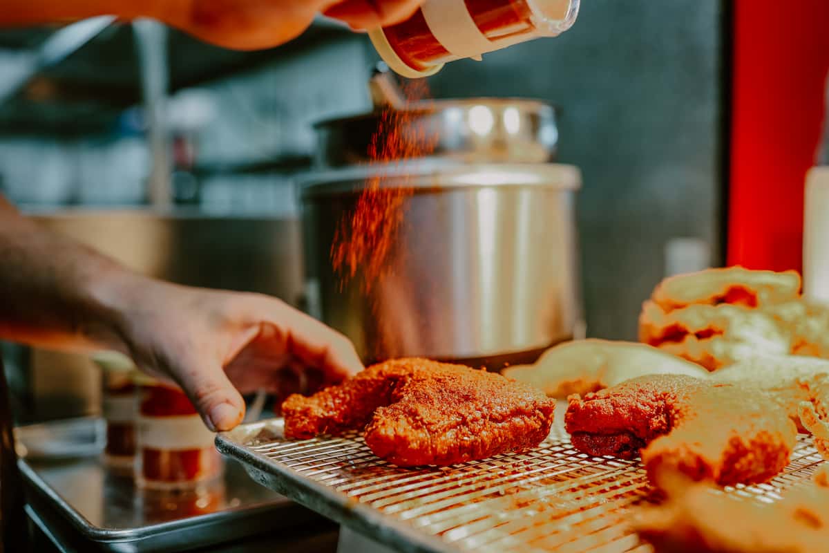 Person seasoning a chicken