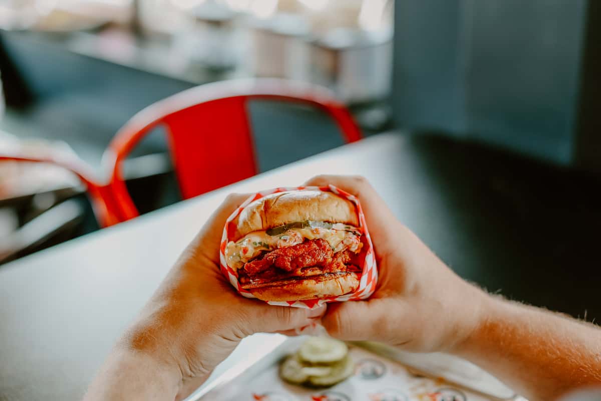 Person eating a chicken sandwich