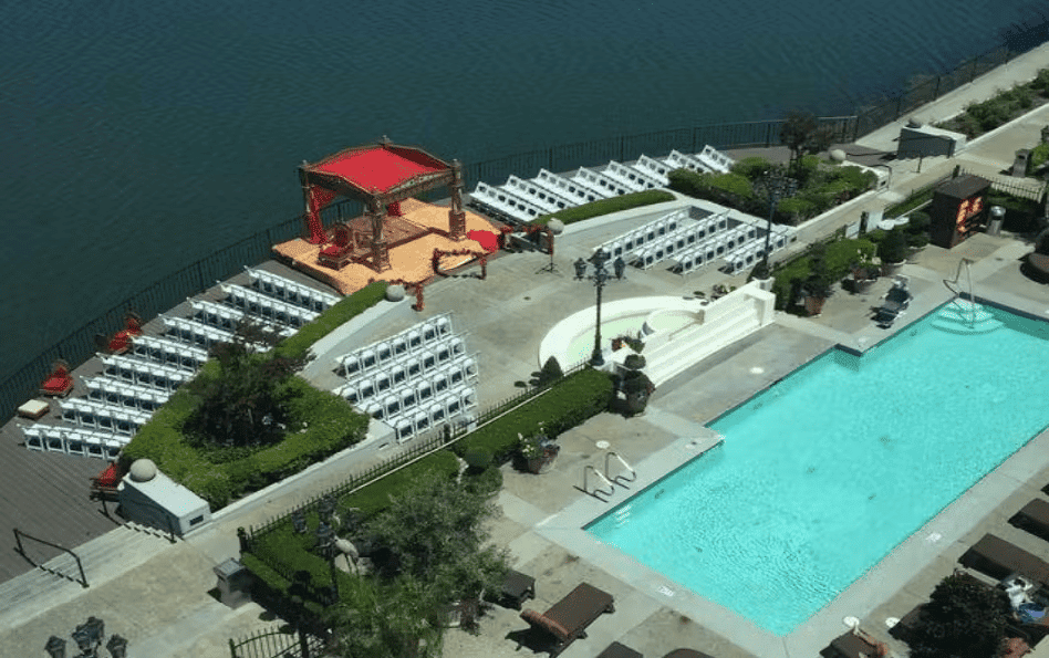 Outdoor waterfront event venue with poolside seating and scenic aerial views for weddings and private celebrations