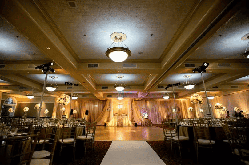 Elegant ballroom entrance with warm lighting, draped decor, and upscale banquet event atmosphere