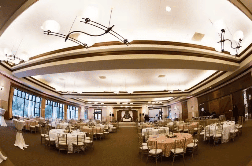 Elegant banquet hall with round dining tables, chandeliers, and sophisticated ballroom event ambiance