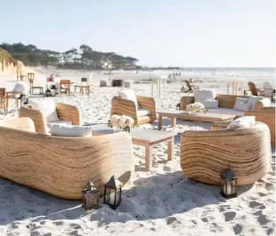 Beachfront lounge seating with ocean views, woven furniture, and relaxed luxury resort atmosphere