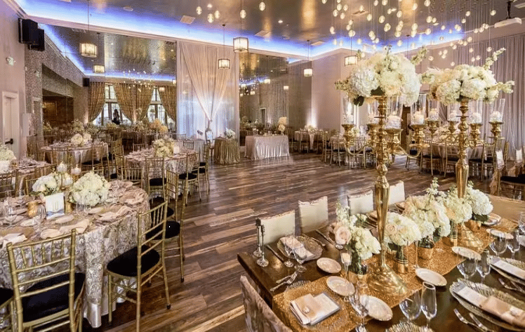 Luxury wedding reception space with floral centerpieces, ambient lighting, and elegant ballroom decor