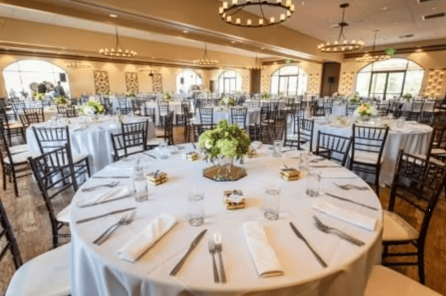 Modern banquet dining room with round tables, floral centerpieces, and sophisticated event venue ambiance
