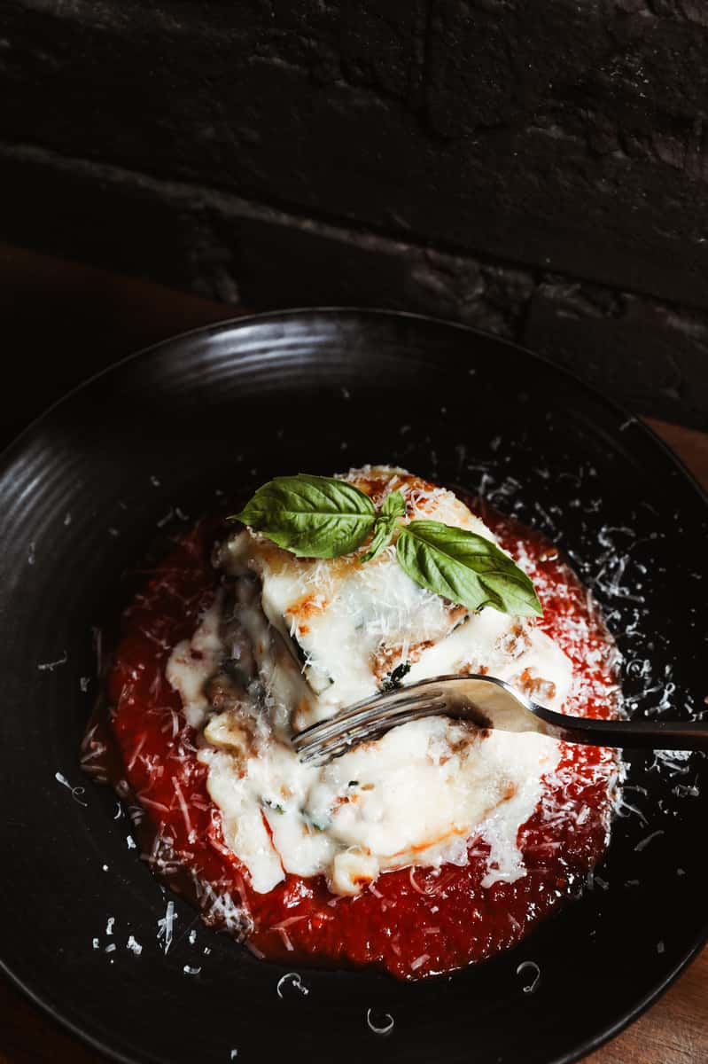 Italian dish with rich marinara sauce, mozzarella and fresh basil