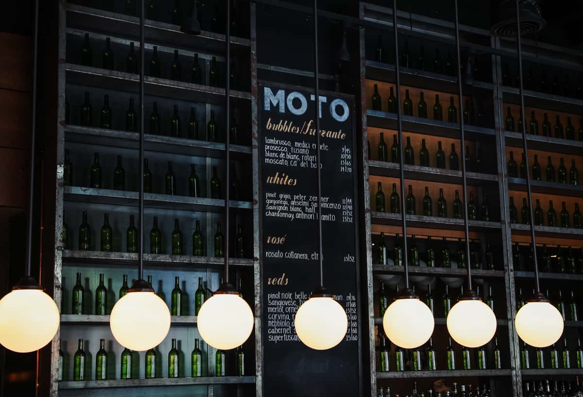 Wine and liquor storage with chalkboard drink menu