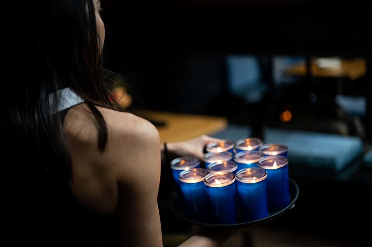 server carrying tray of candles