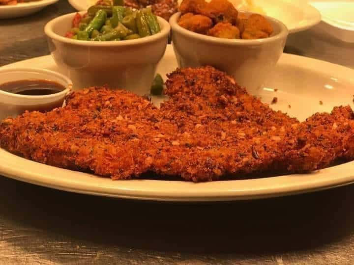 Crispy fried chicken on plate with side of green beans