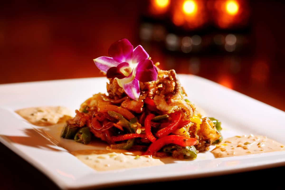 Plate of food with a purple flower