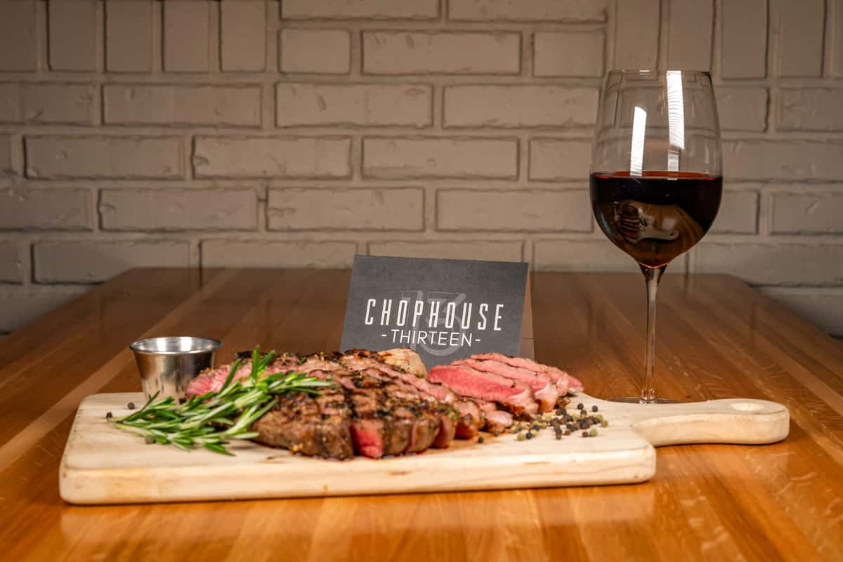Cowboy steak with glass of red wine