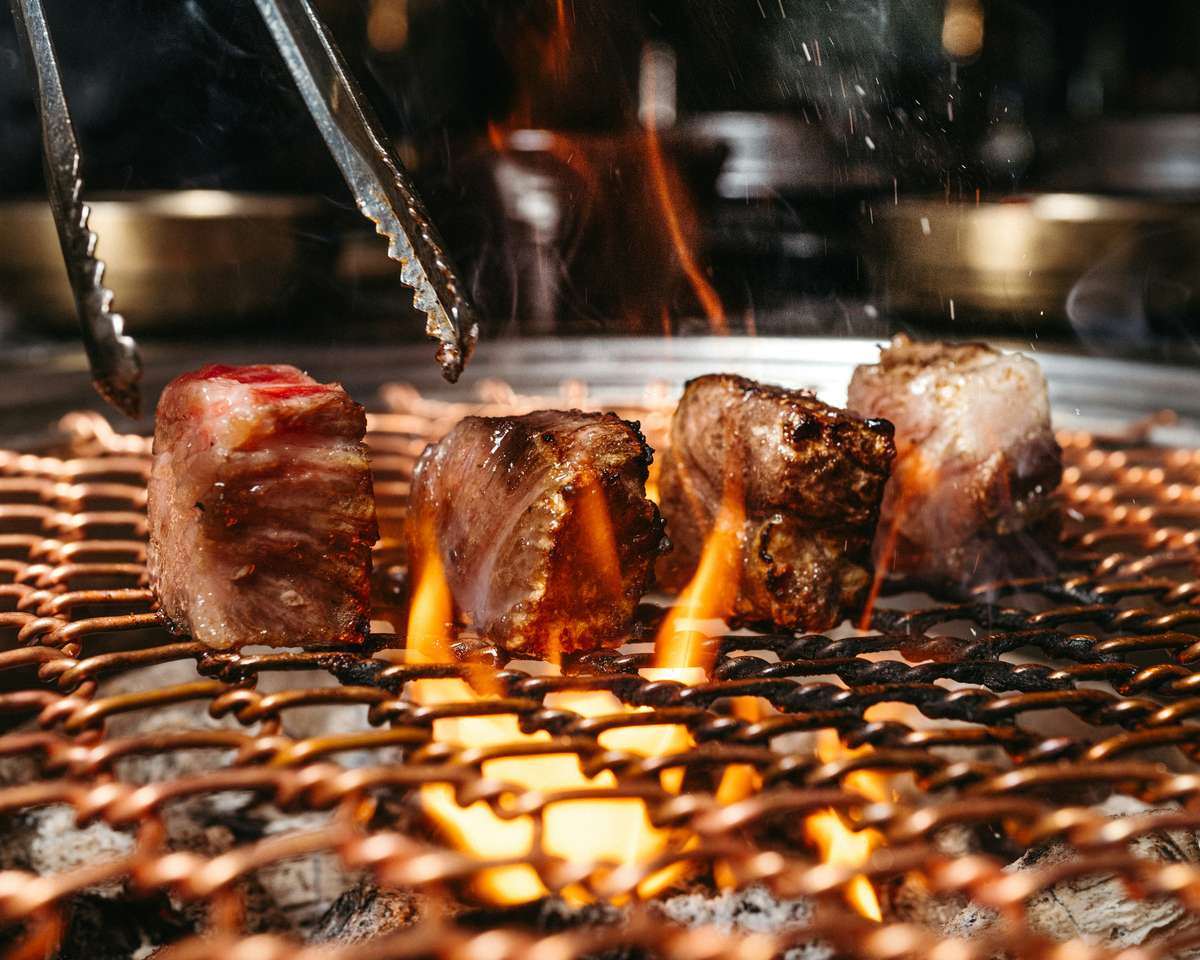 Grilled meat cubes on a BBQ