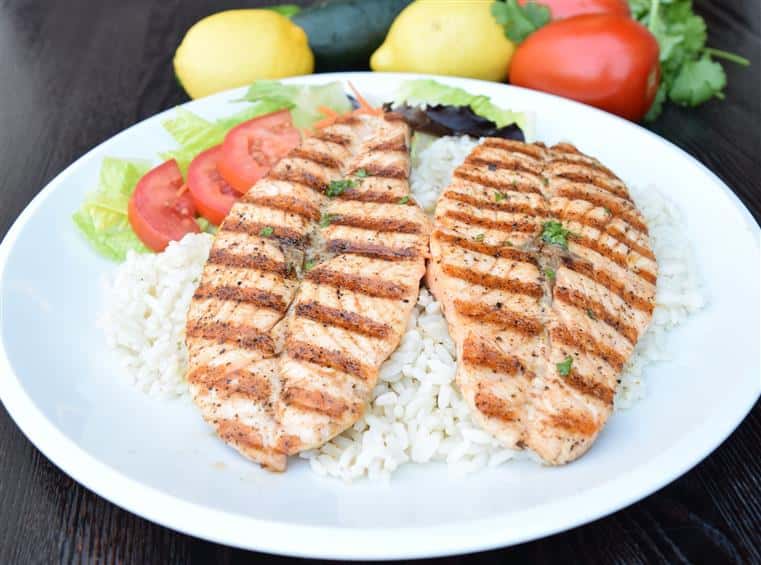 two grilled salmon filet's on a bed of rice