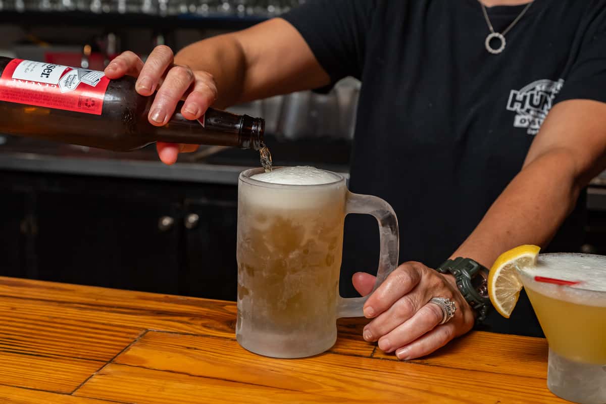 Man pouring a beer on a mug