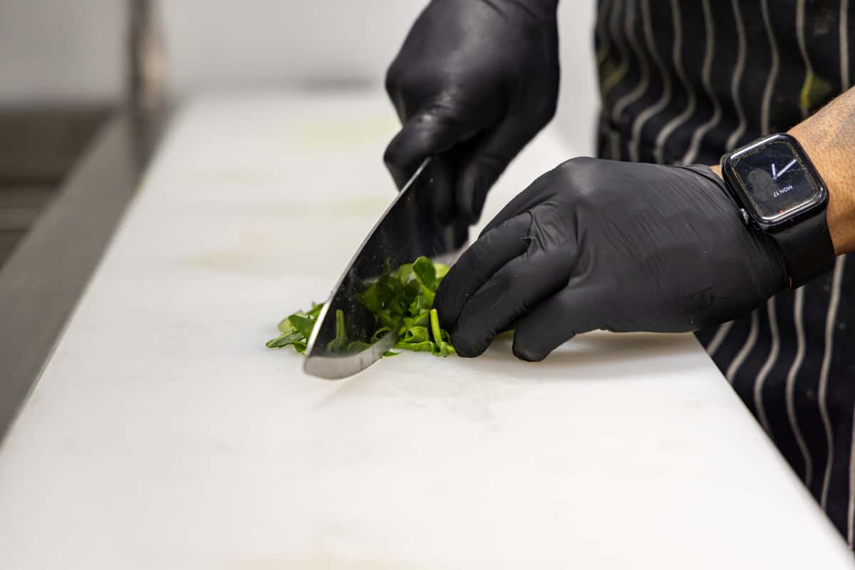 Person cutting salad