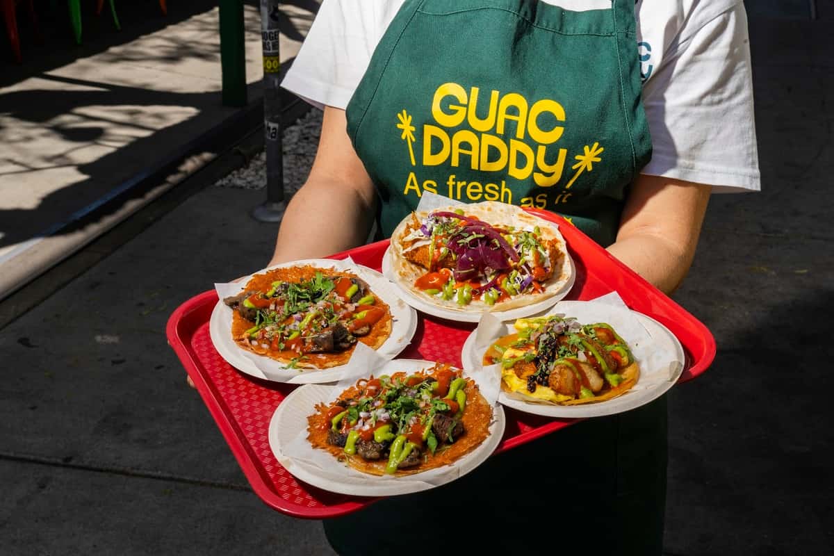 Four tacos on a tray