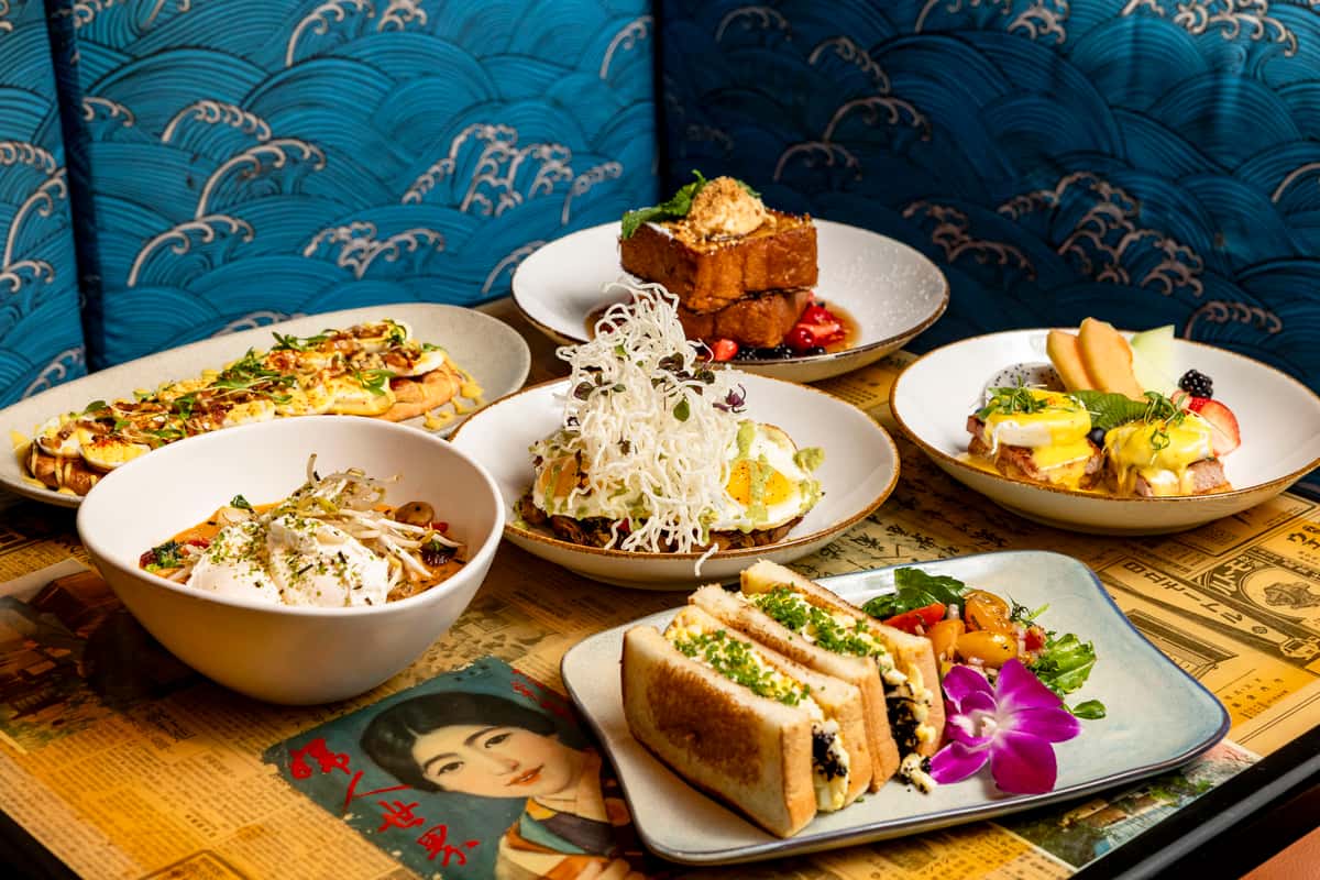Modern Asian fusion spread at Kapow! Noodle Bar featuring sushi, sandwiches, rice dishes, and shareable plates in a vibrant Boca Raton and Delray Beach dining atmosphere.