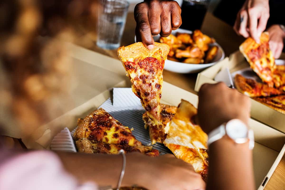 people sharing pizza