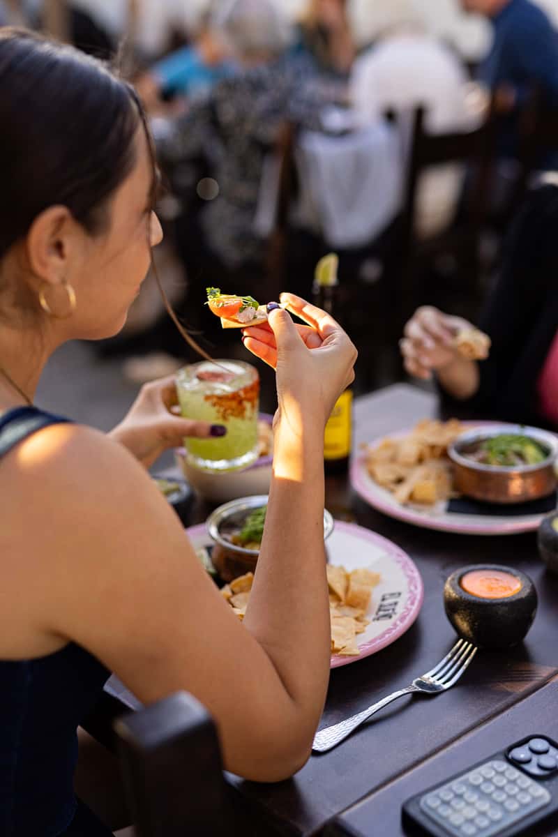 Woman enjoying a delicious entree on an outdoor dining patio