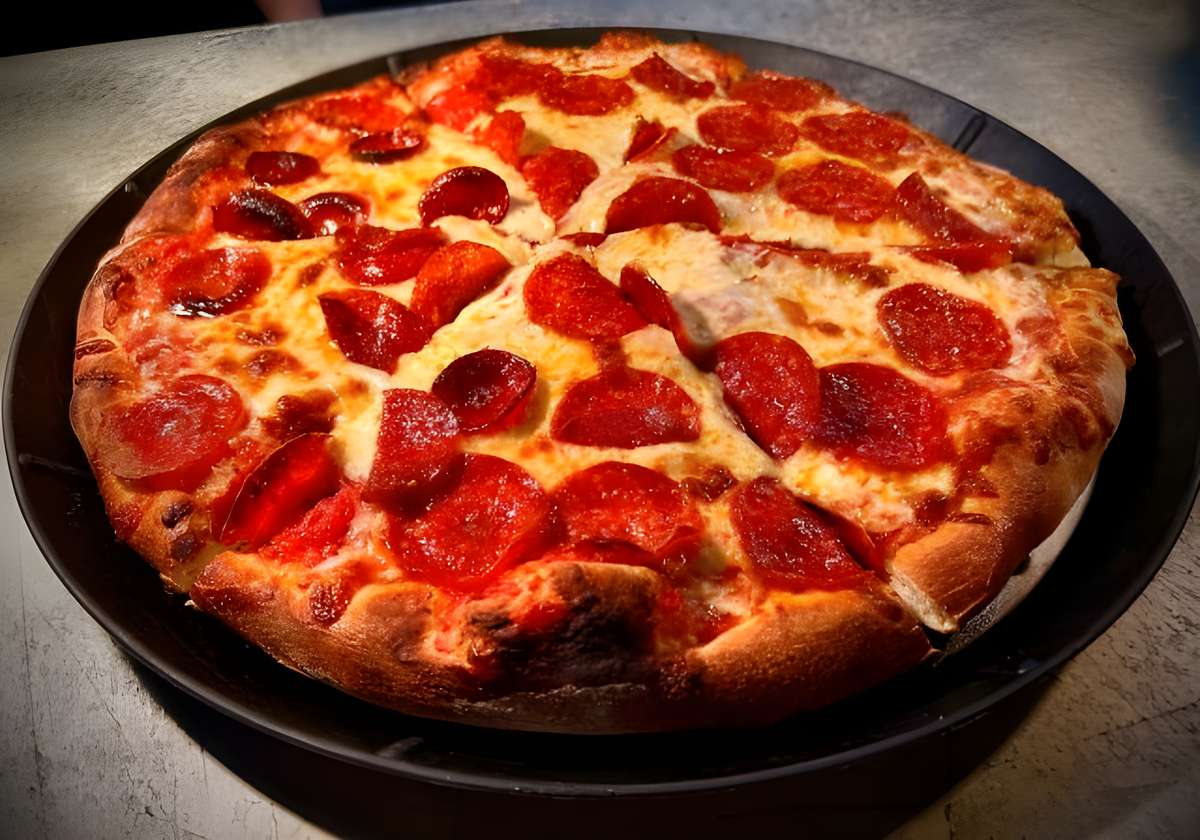 A classic round pizza with a thick crust, topped with melted mozzarella cheese and plenty of sliced pepperoni.
