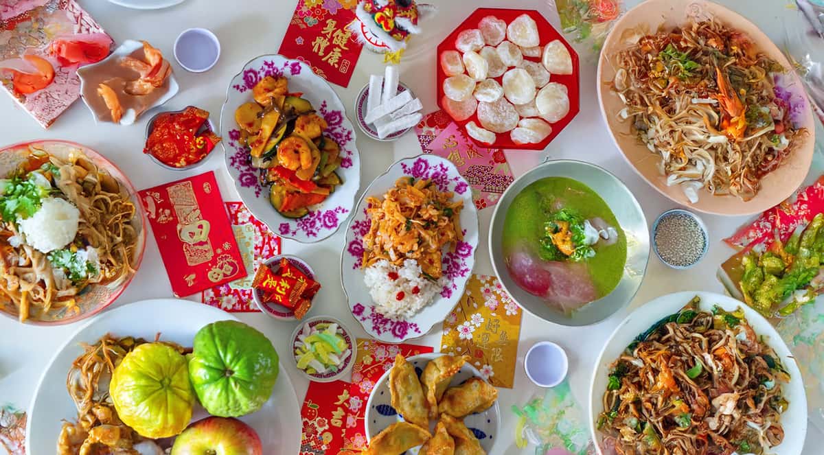 A very wide spread of various Asian fusion meals served at a table to feast
