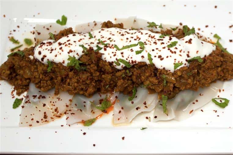 AUSHAK: Thin dumplings filled with leeks and spring onions sprinkled on top with our meat sauce, garlic-yogurt and mint