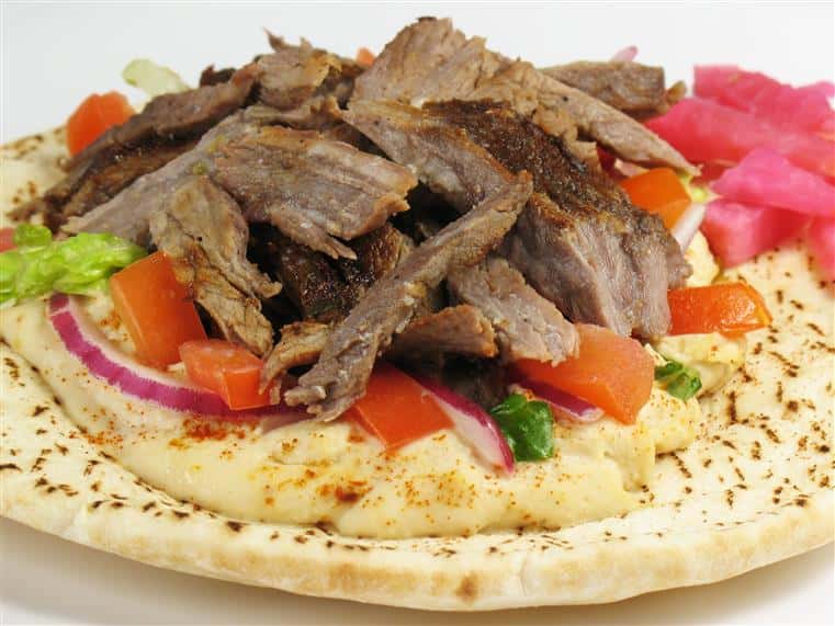 SHAWARMA “MIDDLE EAST GYRO”: beef thinly sliced wrapped in our pita bread. Spread with hummous with fresh tomatoes, chopped lettuce, parsley, garlic-yogurt. Then completed with our delicious yogurt dressing “white sauce”. Served with fries.