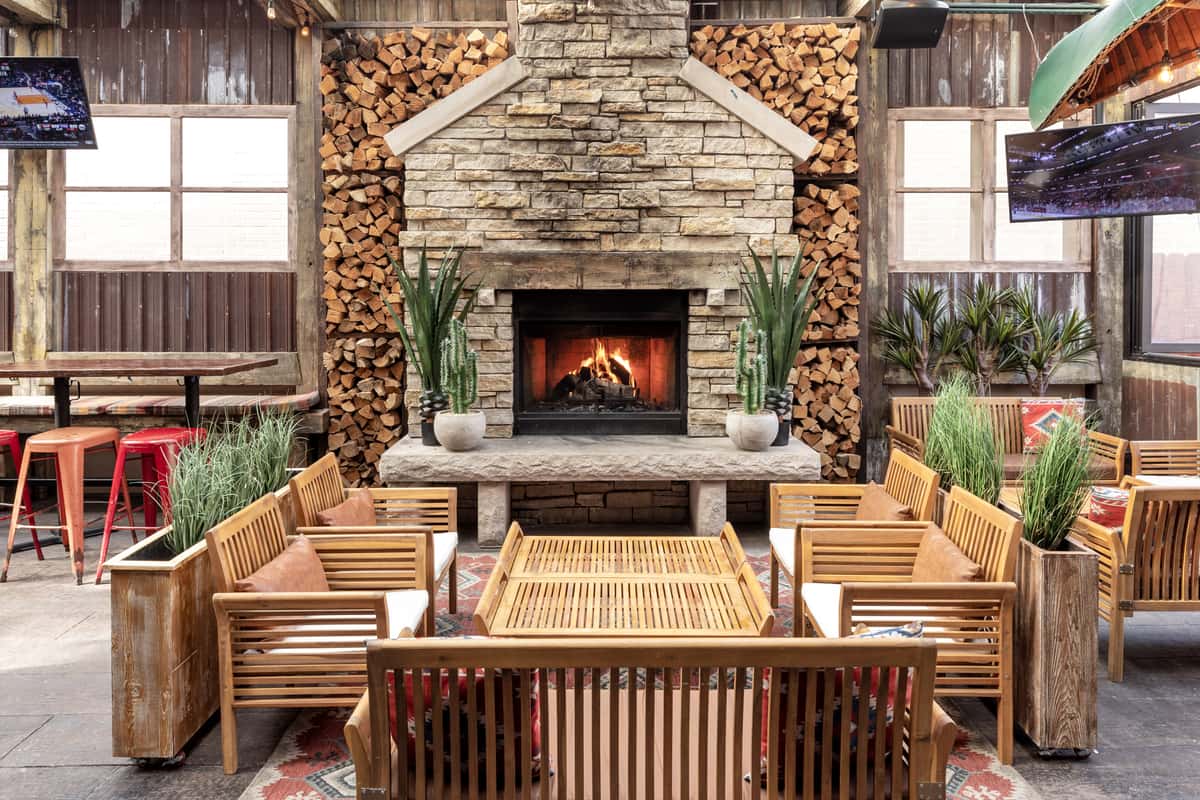 low dining table in front of a rustic indoor fireplace