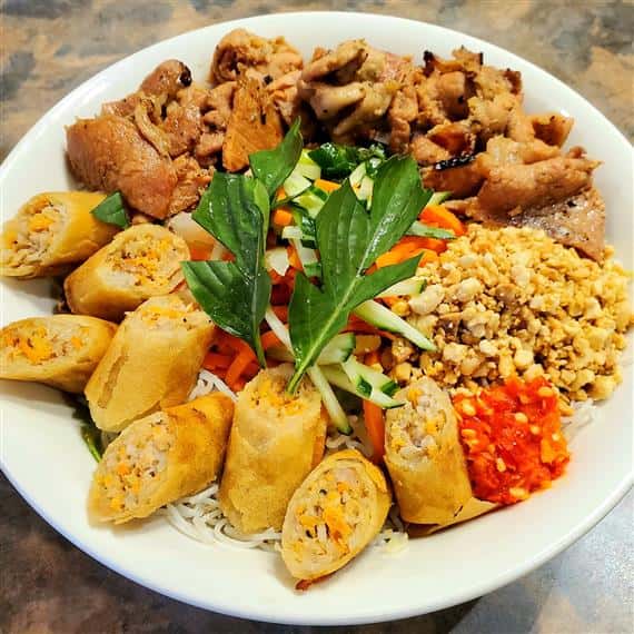 Marinated Grilled Pork with Double Fried Pork Springrolls. Served on a Bed of Rice Vermicelli, Shredded Lettuce and Beansprouts. Garnished with Fresh Cucumber, In House Pickled Carrots, Crushed Peanuts and Tasty Green Onion Oil