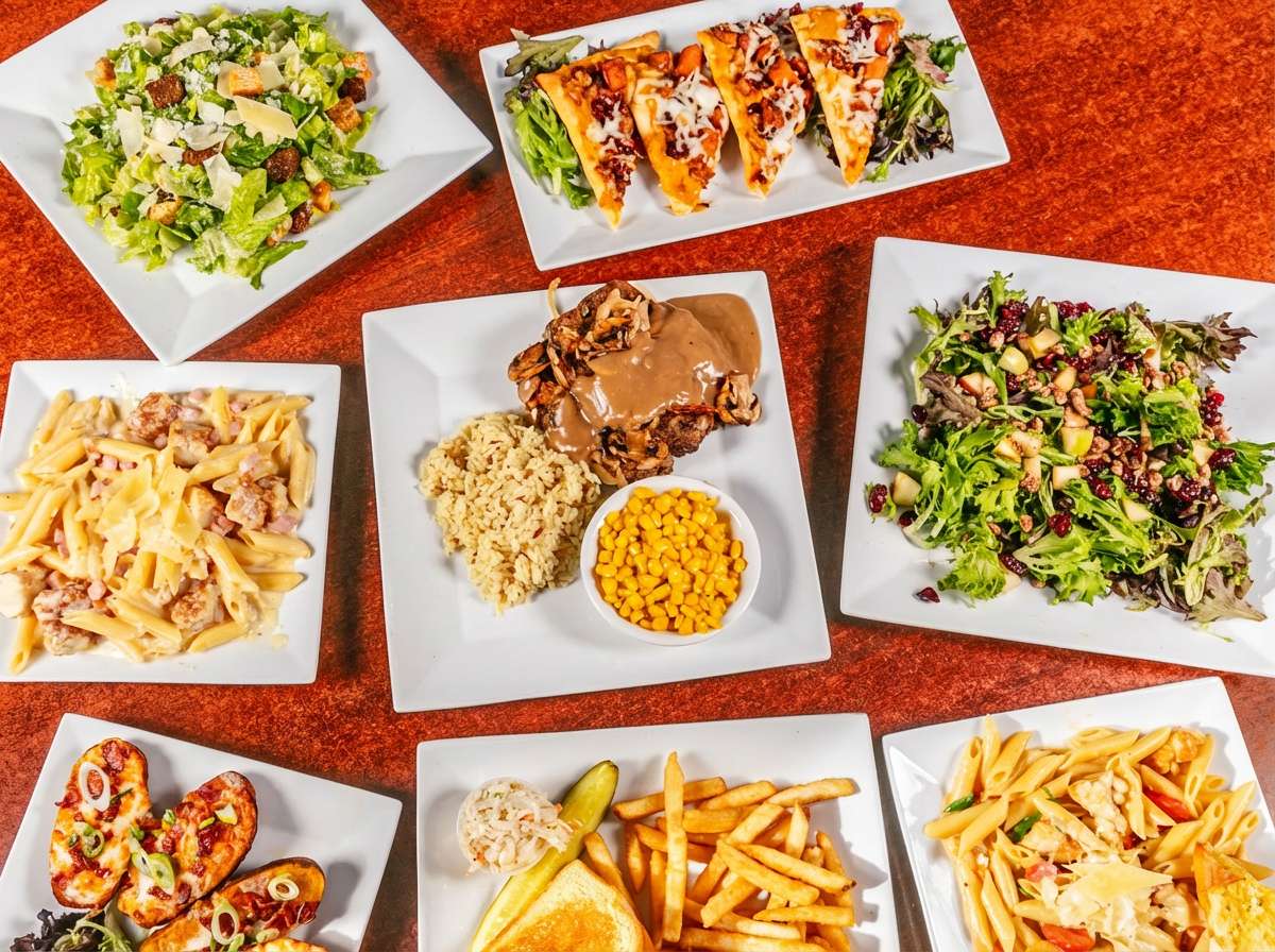 Variety of food on white plates on a wooden table