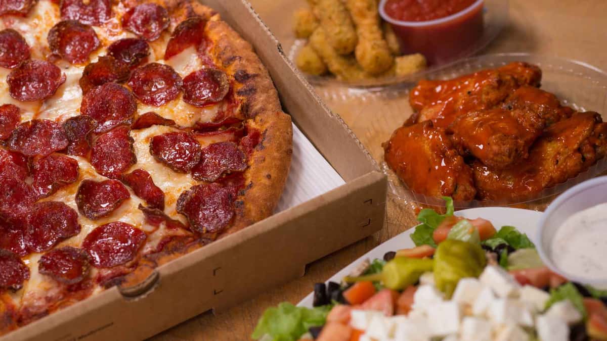 pepperoni pizza, mozzarella sticks, wings, and salad