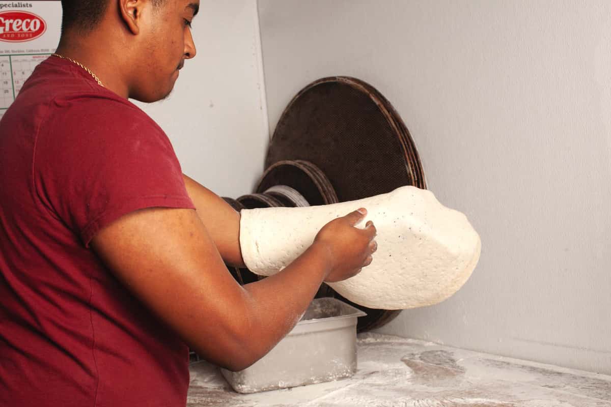 Team member handling dough