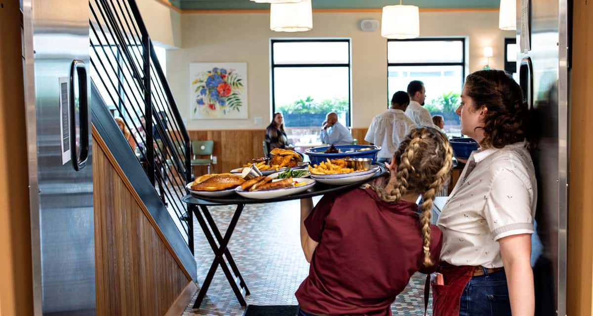 servers holding food tray