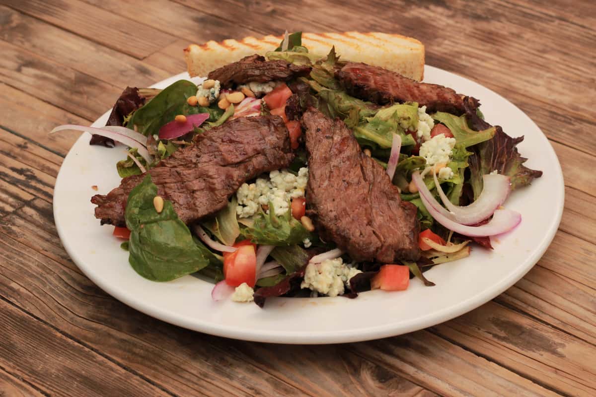 fresh grilled steak, red onion, tomatoes,
mushroom, bleu cheese crumbles & pine nuts
on a bed of baby spinach w/balsamic vinaigrette