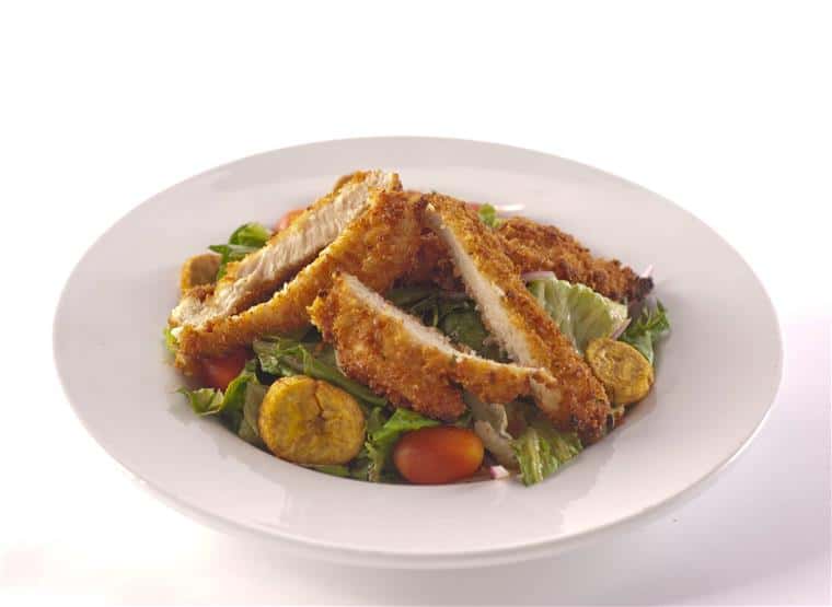 fried chicken fingers over a salad