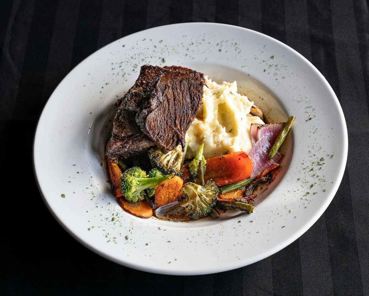 steak with mashed potatoes and vegetables