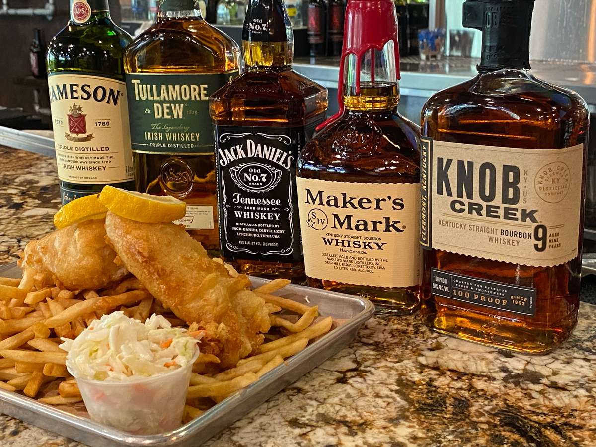 bottles of whiskey with fish and chips
