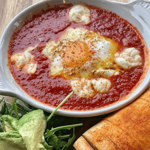 Cheesy Shakshuka with Egg poached in tomato sauce and fresh mozzarella