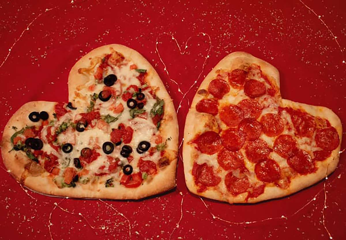 Two pizzas in the shape of a heart.
