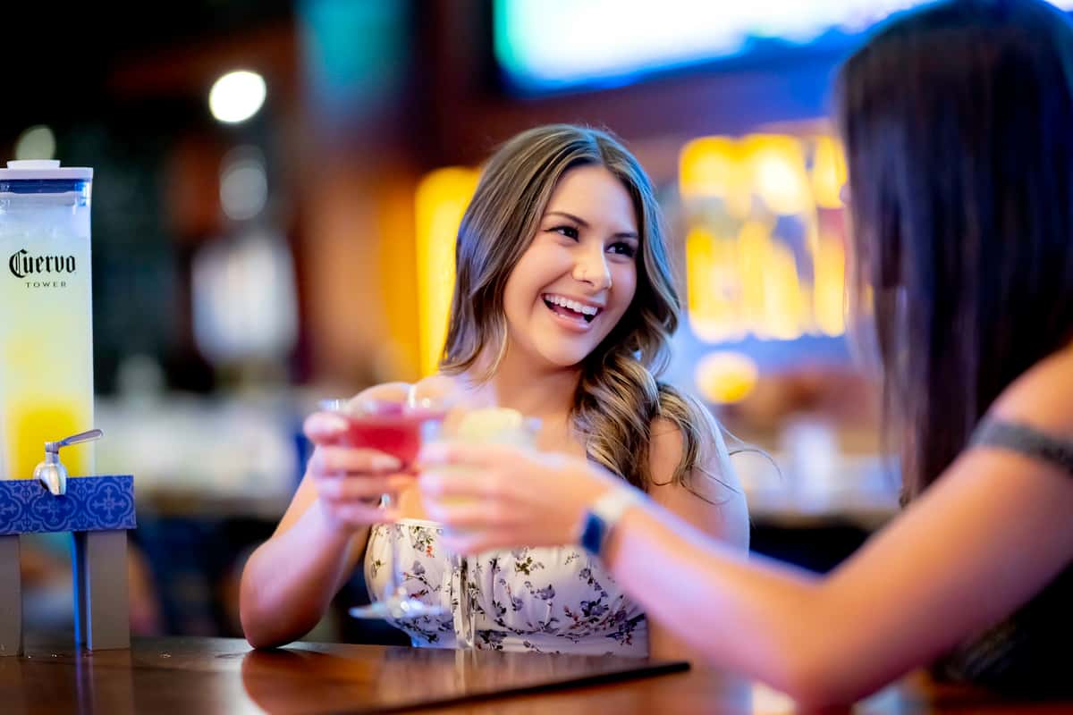 Two women cheering drinks