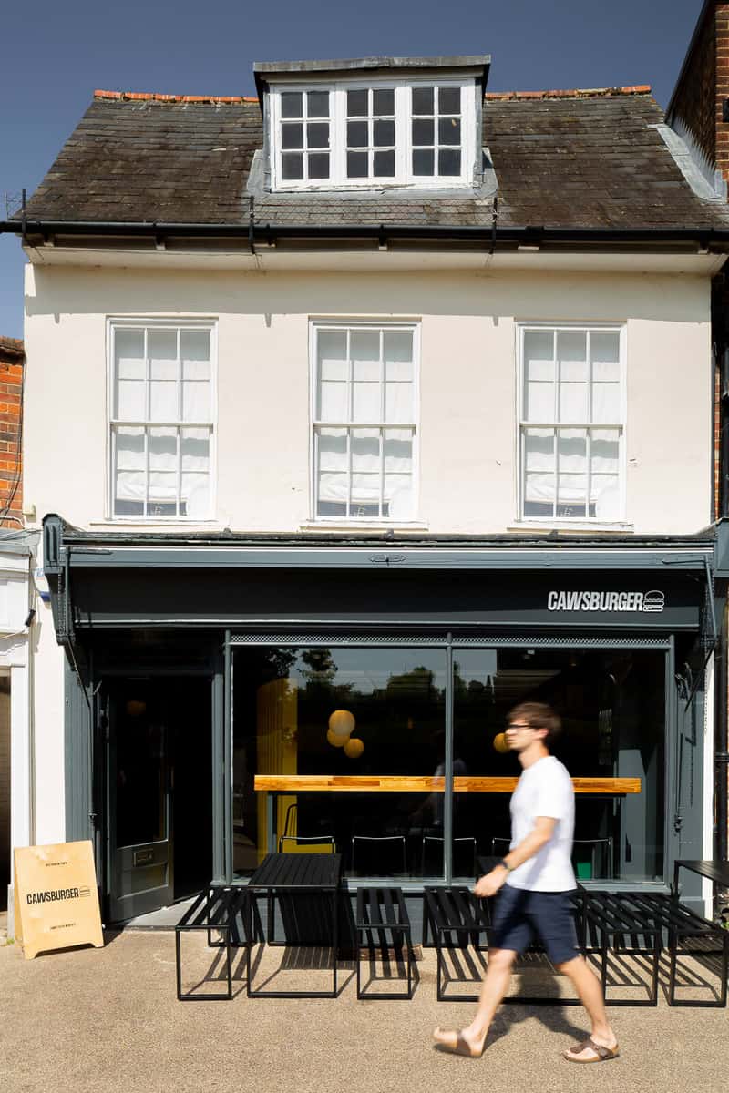 modern burger restaurant storefront with black exterior and welcoming entrance
