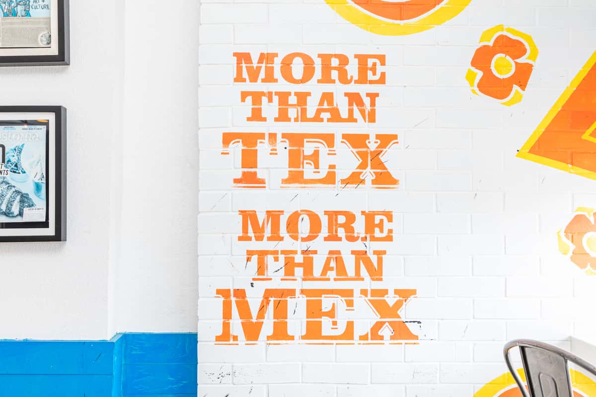 Interior mural with the words "More than TEX, More than MEX"