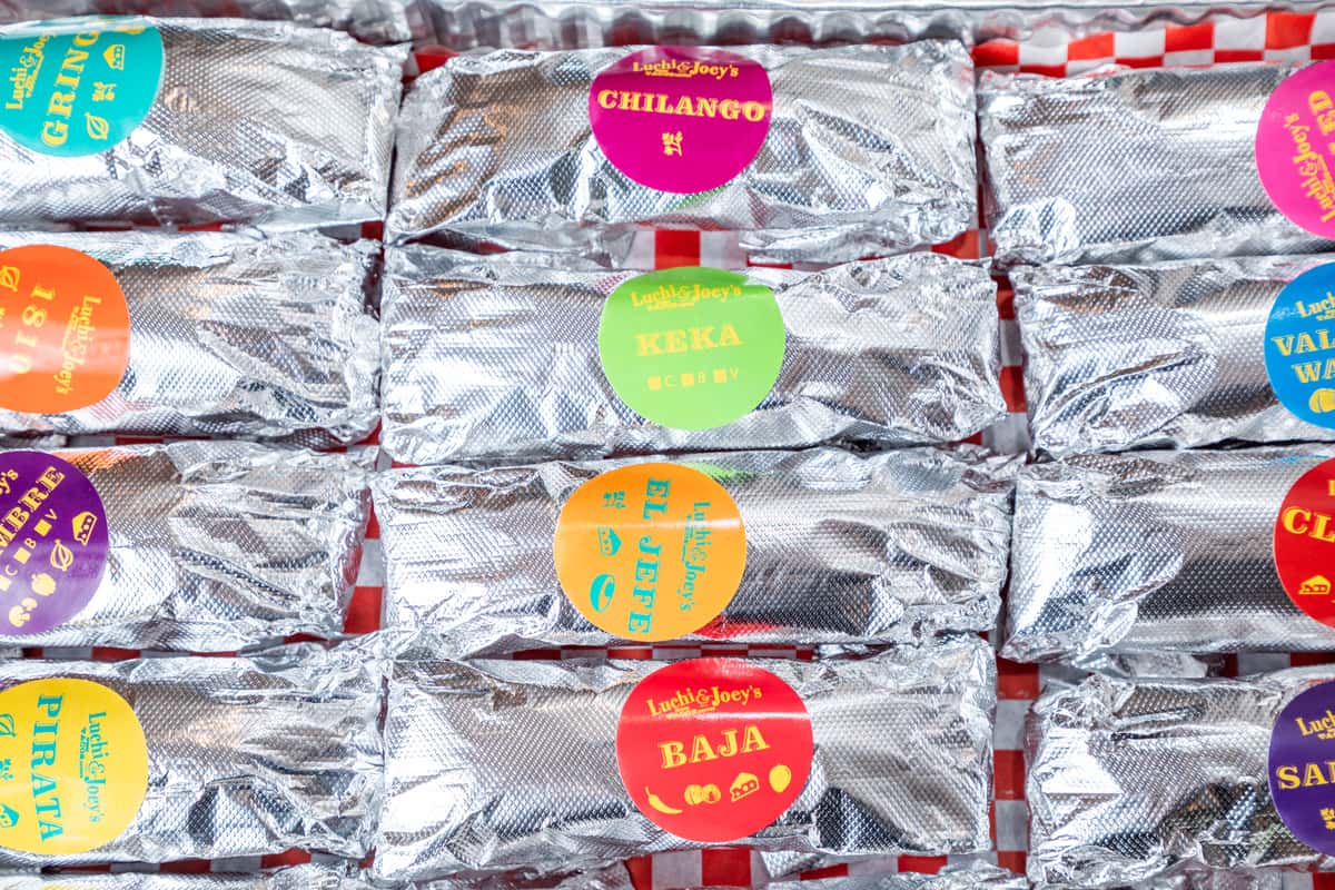 Platter of tacos in tin foil and labeled