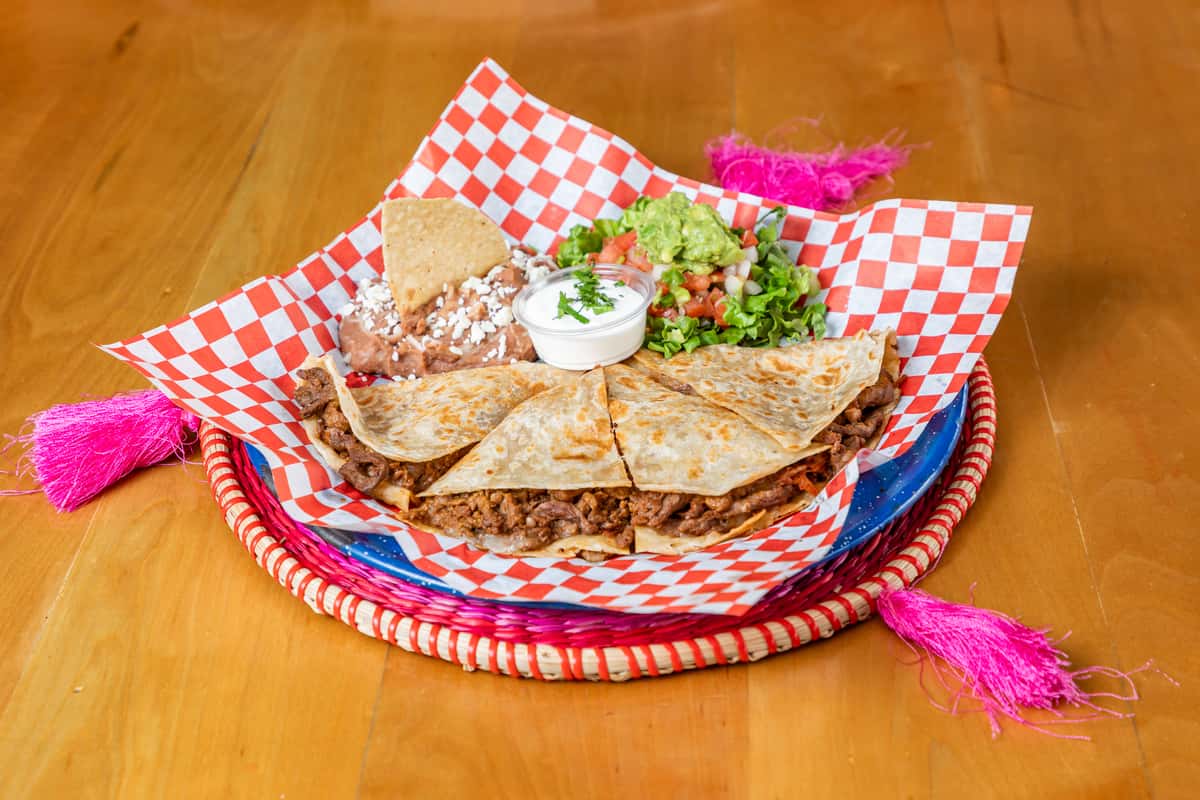 Plate of quesadillas on paper and plate