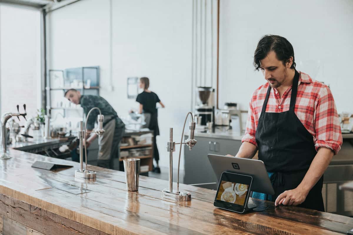 Cashier standing behind a counter
