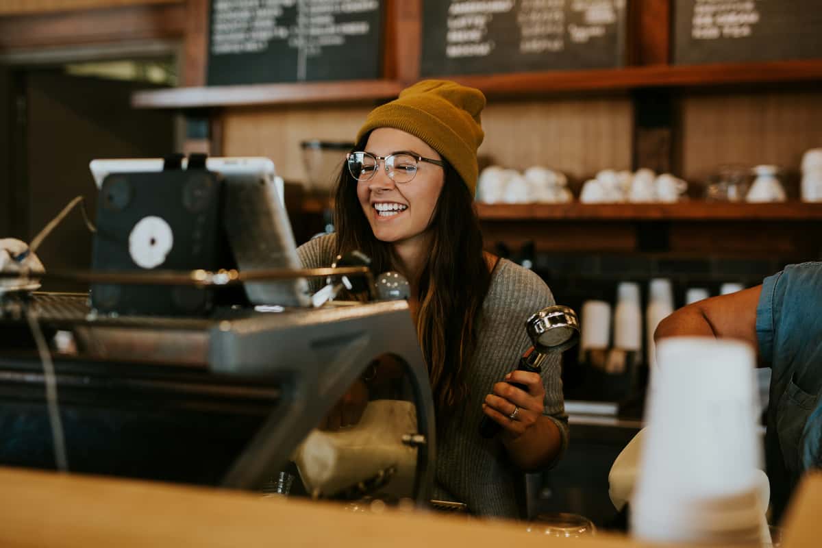 Smiling cashier at a coffee shop