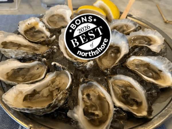 tray of shucked oysters on a tray with sauce and lemon, with Best of Northshore logo