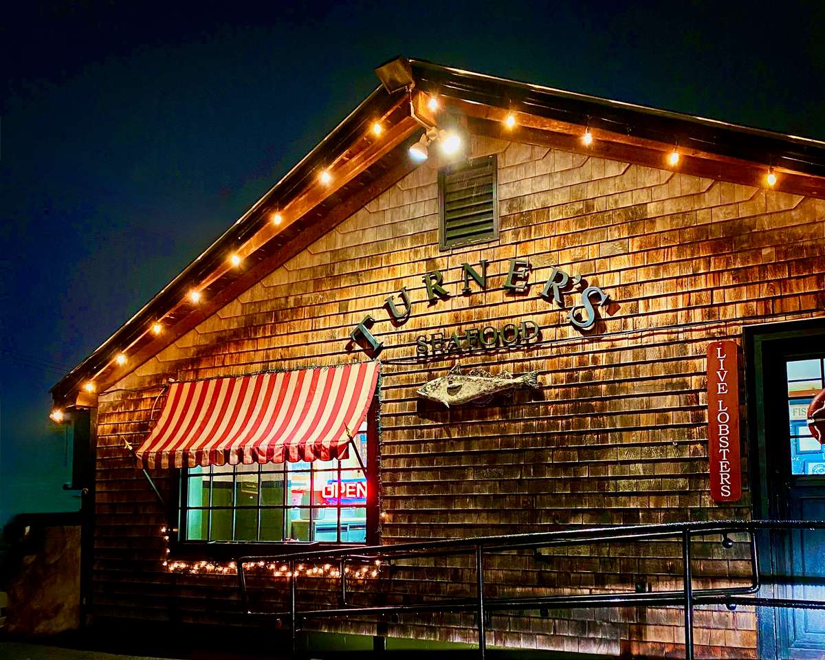 Gloucester store front at night with lights